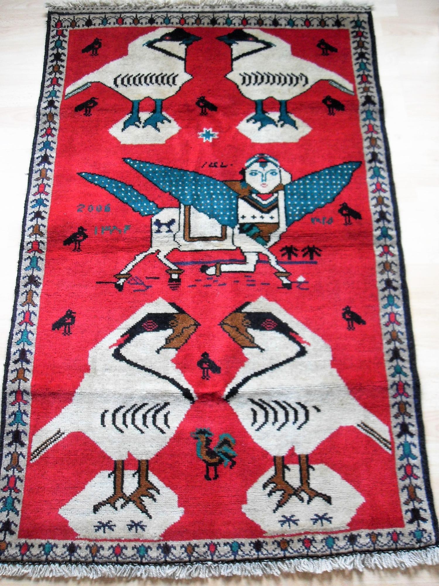 A hand-knotted scarlet-ground tribal pictorial rug with single border and short fringe, 85 x 134