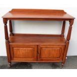 A George IV mahogany buffet or dumb waiter with raised back, moulded top, fluted column supports,