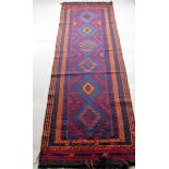 A hand-knotted Afghan Suzani blue-ground wool runner with bright multi-coloured zigzag designs,