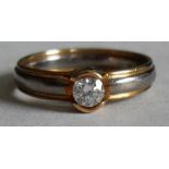 A single stone diamond engagement ring with bi-colour gold band, hallmarked 18ct, 0.1 carat