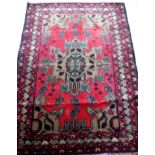 An Afghan hand-knotted Herathi Balochi burgundy-ground wool rug, single border with short fringe, 95