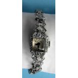 An Art Deco lady's platinum and diamond manual wind cocktail bracelet watch. Rectangular case with