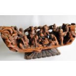 A wood carved depiction of the eight Taoist immortals on a later stand, 20 x 43 x 15cm