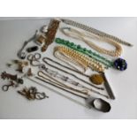 An assortment of silver chains with charms, mixed costume jewellery to include a 1950's Pygmalion-