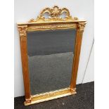 A neo-classical style rectangular gilt-framed wall mirror with elaborately carved cornice and