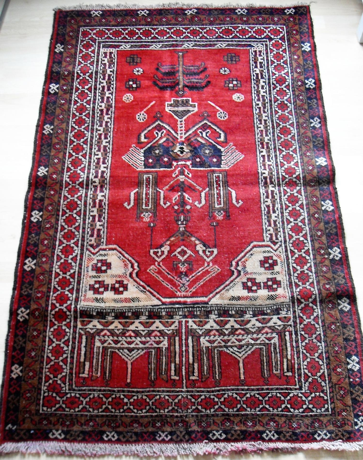 An Afghan hand-knotted burgundy-ground Balochi wool rug with multi-coloured isometric designs, - Bild 2 aus 2