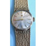 A Tissot lady's 9ct gold bracelet watch, round steel dial, applied yellow batons matching to arrow-