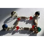 A stone-mounted yellow gold bracelet with fluted bar links and assessed agate, lapis lazuli, emerald
