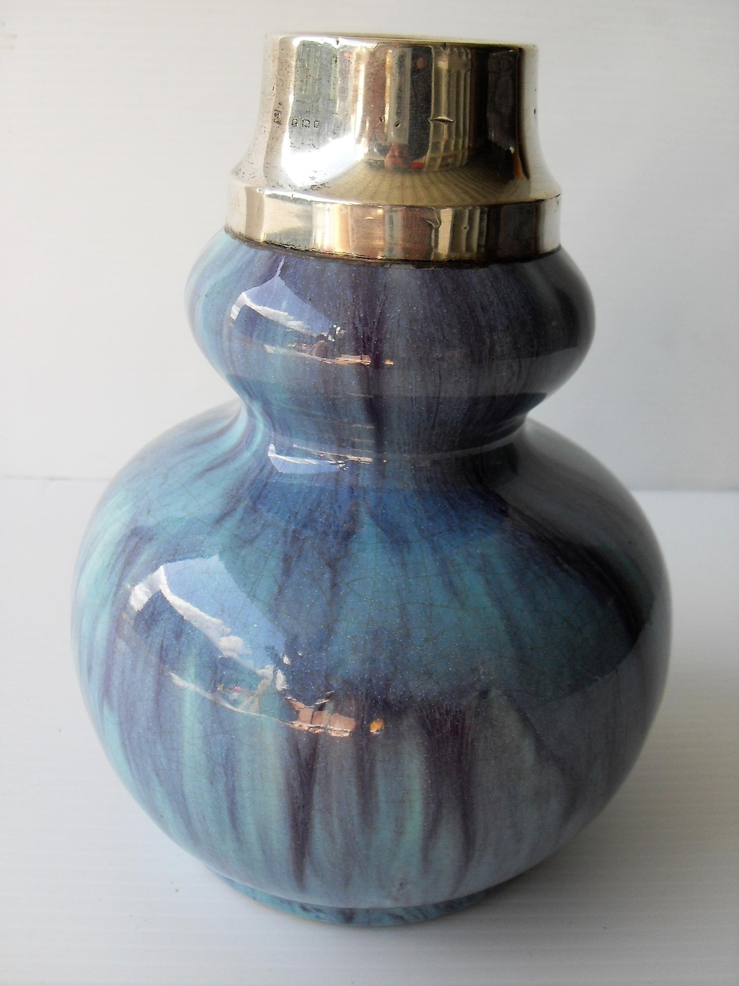 A gourd-shape pottery vase with attractive drip glaze and silver collar, London 1920, without damage