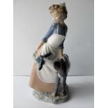 A NAO retired figure of a girl feeding her goat, no. 10207, without damage or repair