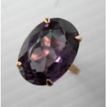 An 18ct yellow gold oval mixed-cut corundum ring, 18.10 x 13.2 x 7.96mm approximately in claw