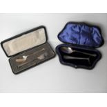 An Edwardian silver cased child's pusher and spoon and a cased rat-tailed spoon and fork all by
