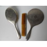 A George V lady's silver three-piece brush set with engine turned design, monogrammed, Birmingham