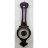 A late Victorian carved oak-framed aneroid banjo-shape barometer and a circular wall barometer