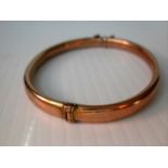 A 9ct yellow gold bangle, hallmarked for Birmingham with slight dents, 7.17g