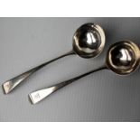 A pair of George III silver sauce ladles with armorial crests by Stephen Adams, 18cm, London 1799