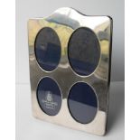 A London silver four-oval aperture plain photo frame with domed top, each aperture 8.5 x 6 cm