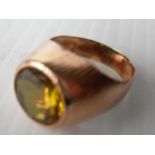 A 14ct rose gold synthetic yellow sapphire dress ring of round mixed-cut. size Q, marks rubbed,