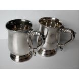 A pair of silver tankards of baluster form, each on a stepped circular foot by E H Parkin & Co,