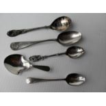 An .800 silver caddy spoon, a Dundee silver souvenir spoon, a Sheffield silver coffee spoon and