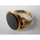 An 18ct yellow gold gent's bloodstone-set signet ring, 16mm x 8mm, size T 1/2 stamped and testing