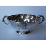 An early 20th century Mexican silver two-handled lobed bon-bon dish with embossed floral