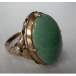 A 14ct yellow gold single stone cabochon jade dress ring, 19 x 13mm approximately in a claw setting,