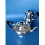 A George V silver tea pot and matching hot water or coffee jug with Bakelite handles and beaded