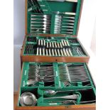 An early 20th century oak-cased 107-piece canteen of silver plated cutlery by Walker & Hall (two/