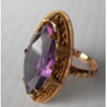 An 18ct yellow gold marquise-shape blue/purple synthetic corundum in a claw setting with rope