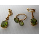 A 9ct yellow gold two-stone peridot ring, size L and a pair of matching clip-on drop earrings to