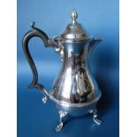 An Edwardian silver hot water or coffee pot of baluster form with spiral finial, ebonised handle