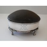 An Edwardian silver pin cushion holder with lift-up lid, lined interior on four trefid feet,