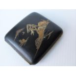 A Japanese Komai black lacquered cigarette case with coloured inlaid metals depicting Mount Fuji