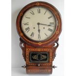 A 19th century American wall clock with Roman numerals, crossbanding and carved decoration to