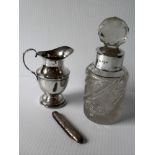 An Edwardian silver cream jug of classical form with c-scroll handle on a spreading foot by S