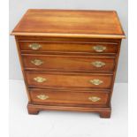A yew wood and crossbanded chest of four long graduated drawers with carved brass drop handles