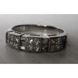 A half-hoop ring set with twelve bar-set princess-cut diamonds each measuring between 1.9mm and