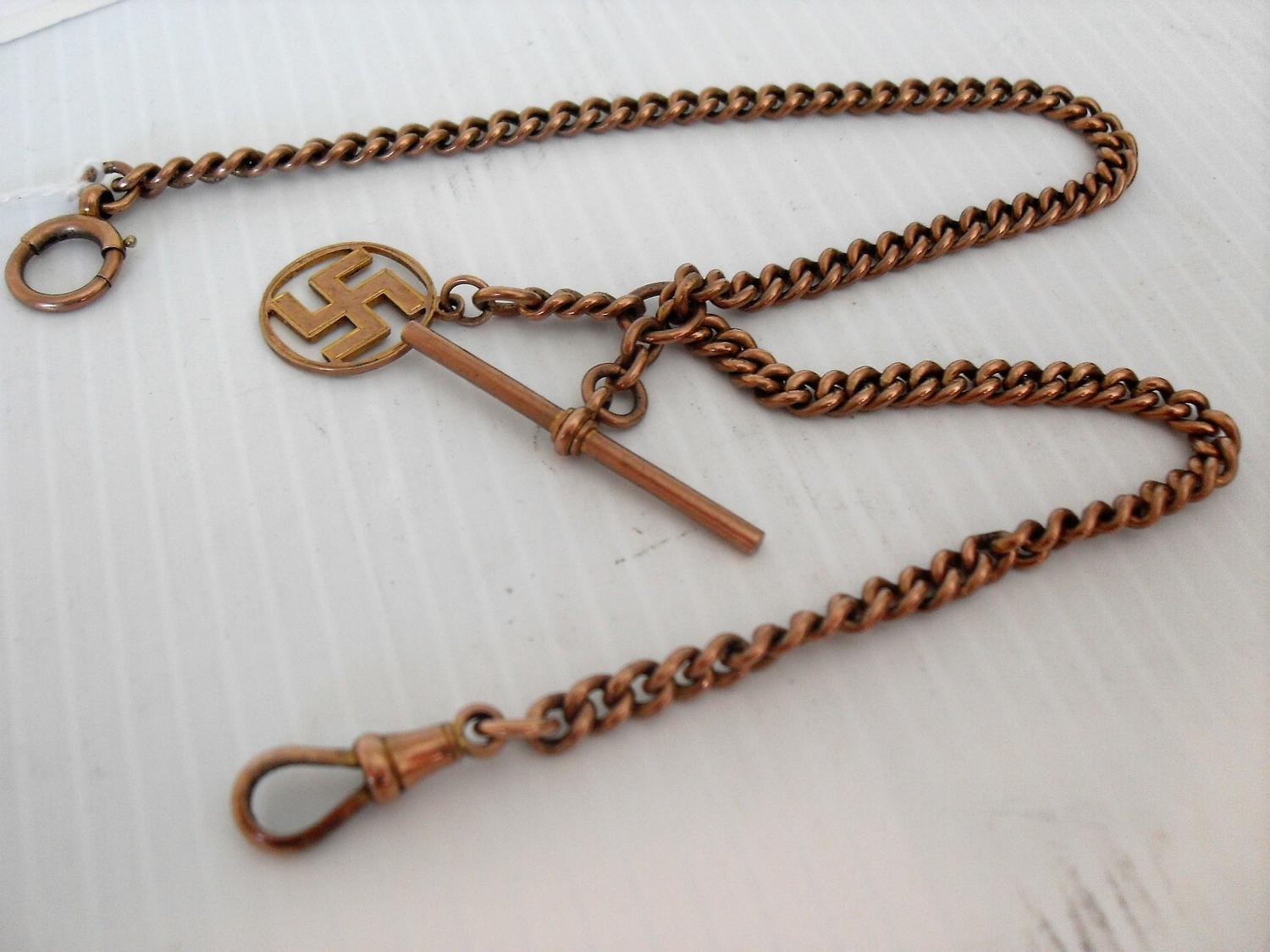 A 9ct yellow gold Albert chain with T-bar and swastika pendant, 37cm, 18g