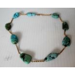 A turquoise beaded necklace on a 9ct gold chain, 37cm