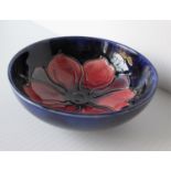 A Moorcroft bowl with anemone pattern and decorator's mark 'K' with small nibble to base, 5 x 11 cm