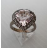 An 18ct white gold pear-shape kunzite and diamond handmade cluster ring in a claw setting, the 22