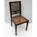 An Empire-style occasional chair with rattan support and seat, carved splat on square tapering