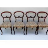 A set of four Victorian spoon-back mahogany dining chairs with carved supports, fabric upholstered