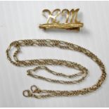 An 18ct yellow gold brooch, 1.71g, 26mm W and a 9ct yellow gold chain, 2.64g, both hallmarked