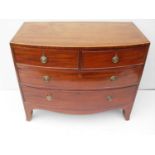 A Georgian mahogany bow-fronted chest of two short and two long drawers with ebony string inlay,