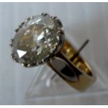 A diamond single stone ring. The oval cut diamond measuring approx. 10.42mm x 7.87mm x 4.97mm depth