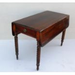 A Regency mahogany Pembroke table with twin drop leaves, frieze drawers with circular brass drop