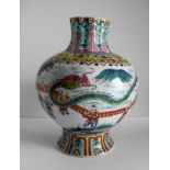 An early 20th century Chinese Qianlong-style polychrome baluster-shape vase depicting boys