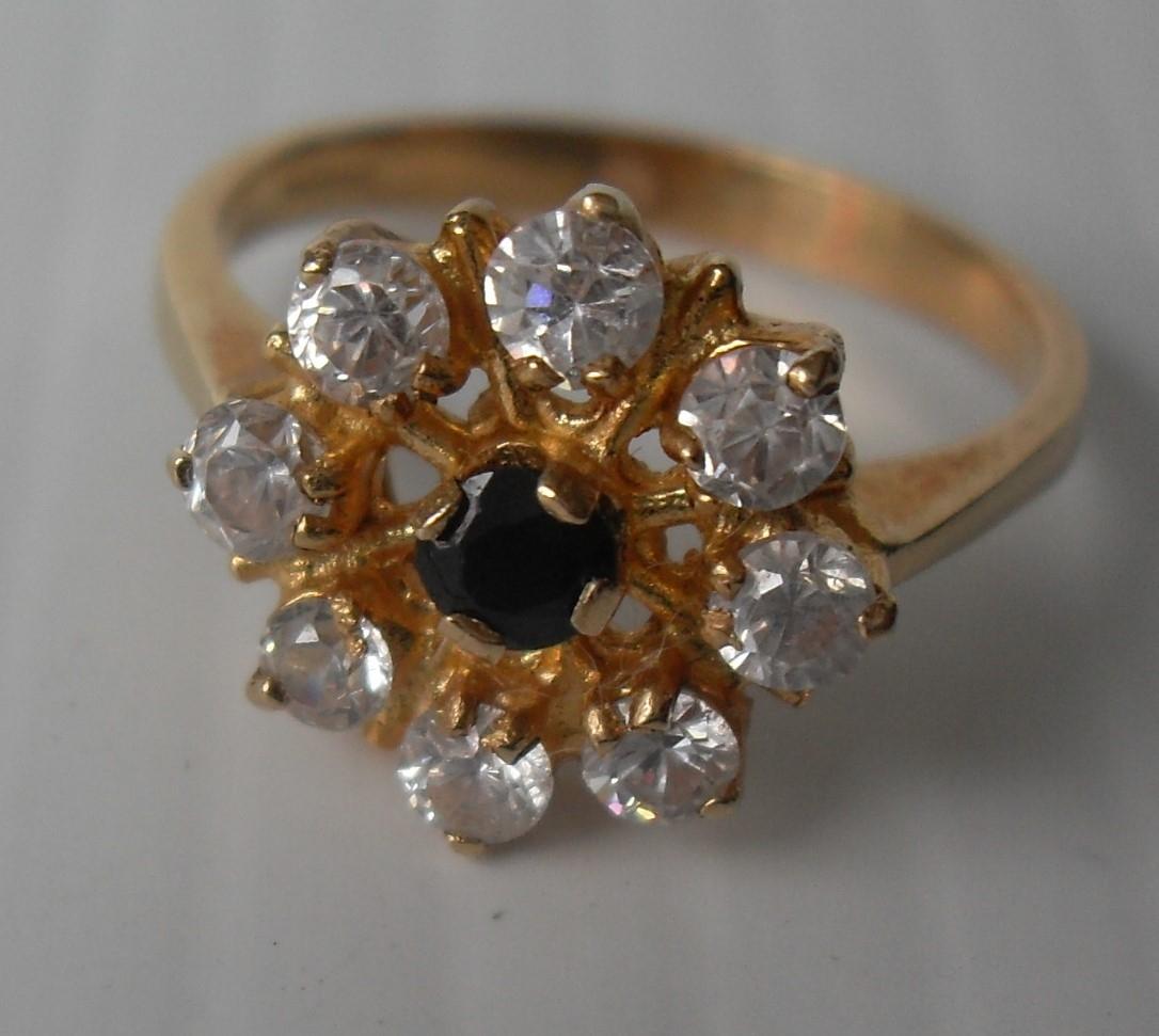 An 18ct yellow gold sapphire and diamond ring is a cage setting, 3.65g, size N (testing for 18ct